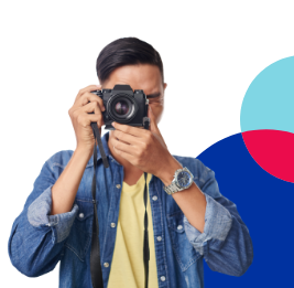 Man in denim jacket taking a picture with an SLR