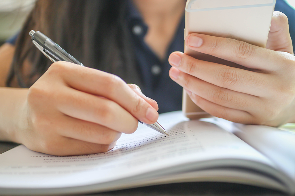 student studying with phone