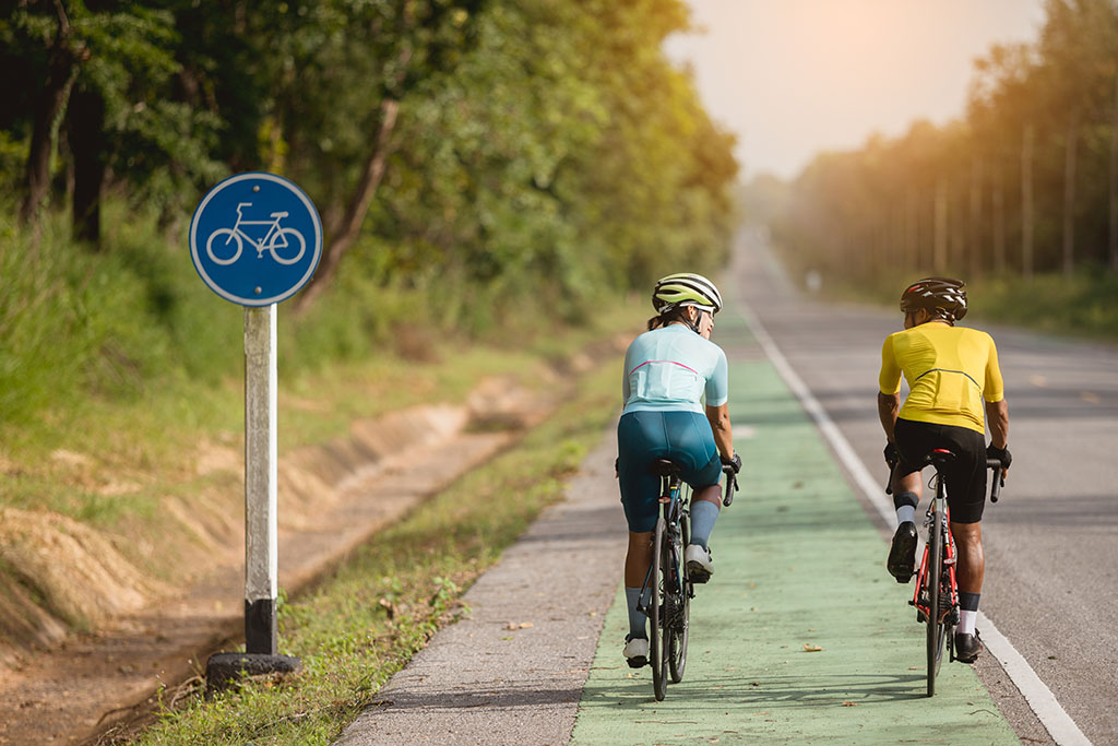 Asian are cycling road bike in the morning