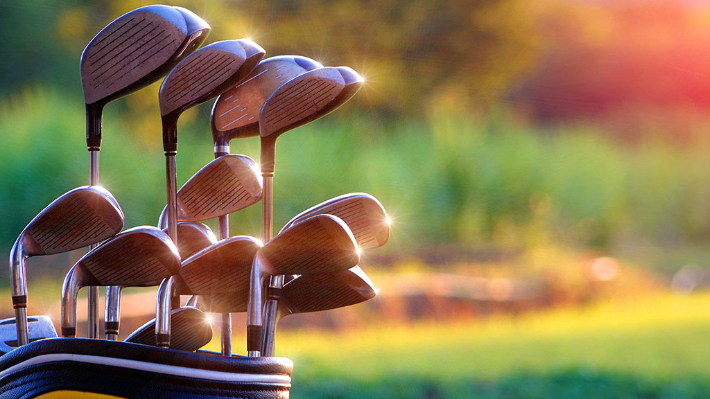 Golf clubs in bag golf equipment on golf stadium background, Golf clubs drivers over green field background