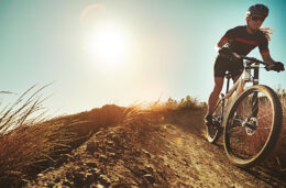 man on a mountain bike riding down a hillside towards the camera