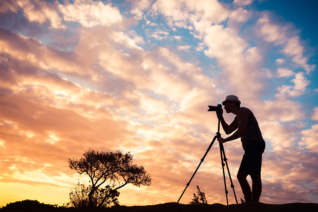 Male photographer taking photos in a beautiful nature setting.