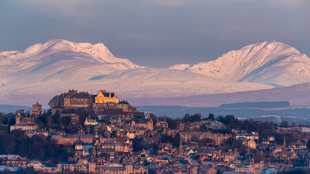 The early morning light on Stirling castle and wintery hills beyond