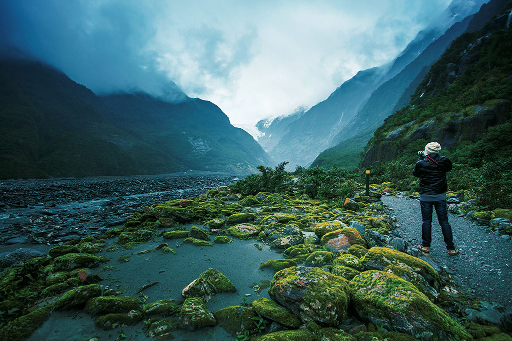 traveling man take a photograph in franz josef glacier important traveler destination in south island new zealand